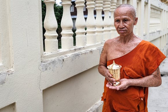 A monk with the cremated remains of Thanchanok Donhomla at her home town in Kalasin province. 