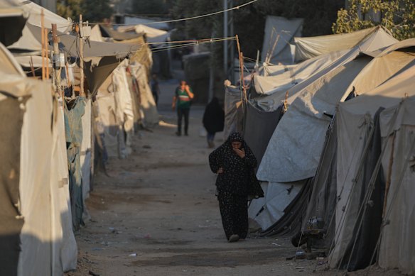 A Palestinian woman walks along tents at a makeshift camp for displaced people in Deir al-Balah, central Gaza Strip, last week.