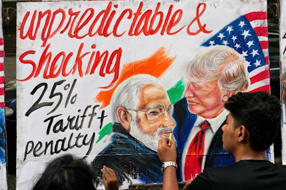 A student of Gurukul School of Art in Mumbai puts the finishing touches to his take on the relationship between Donald Trump and Indian Prime Minister Narendra Modi.