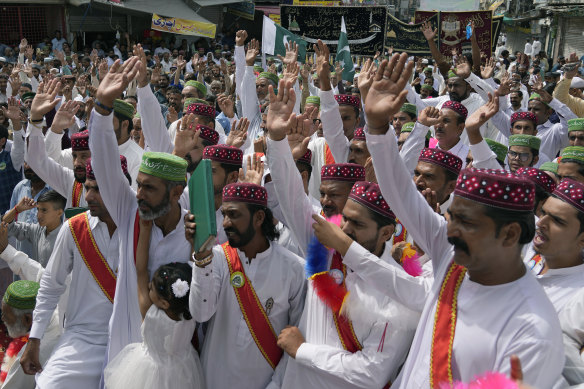 Muslims chant religious slogans during a rally celebrating the birthday of Islam’s Prophet Muhammad in Rawalpindi, Pakistan, on Friday. Thousands of Muslims take part in religious processions, ceremonies and distributing free meals among the poor to mark the holiday.