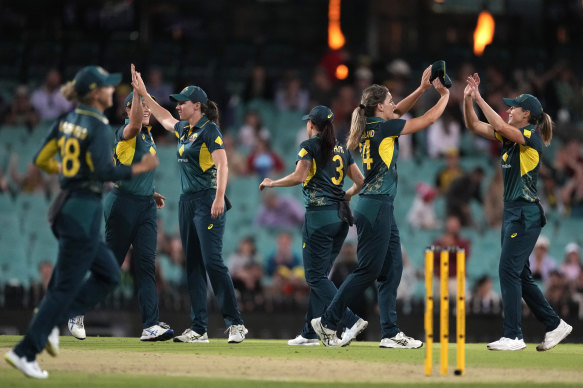 Australian players celebrate their win over England in their Women’s Ashes T20 cricket match in Sydney