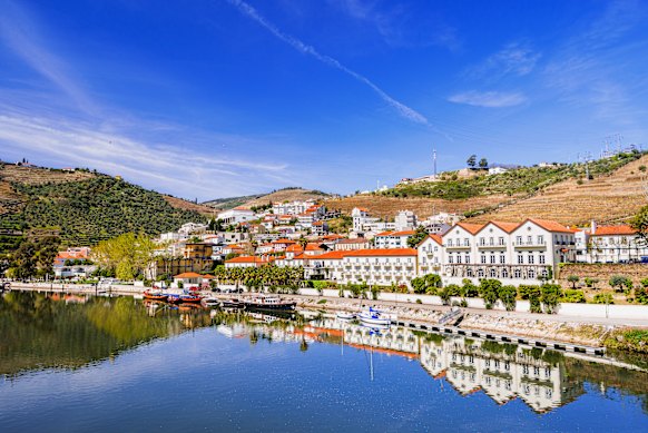 Vineyards and luxury hotels line the Douro River in Pinhao.