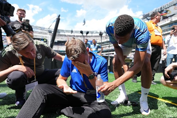 Kylian Mbappe offers water to a bystander during the warm-up of the Club World Cup semi-final