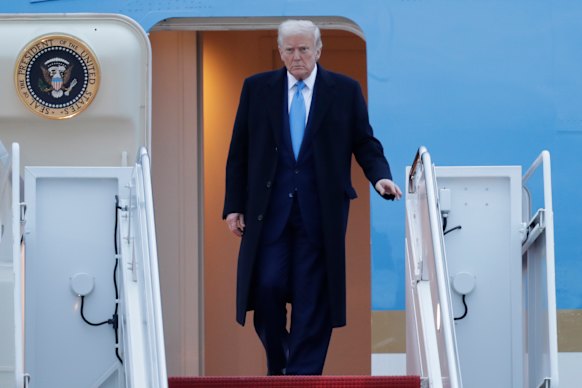 Donald Trump leaves Air Force One on his way back to the White House on Sunday.