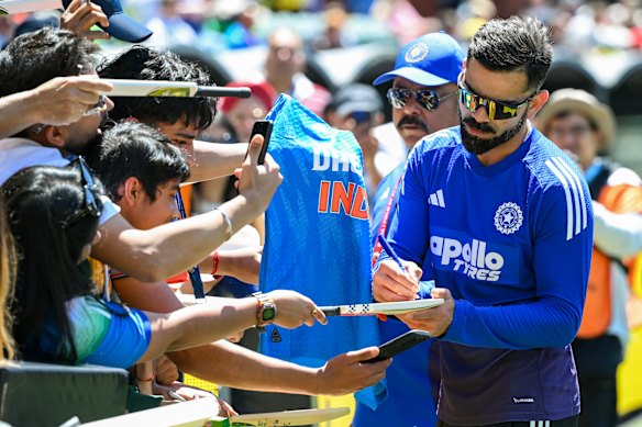 Virat Kohli signs autographs in Adelaide.