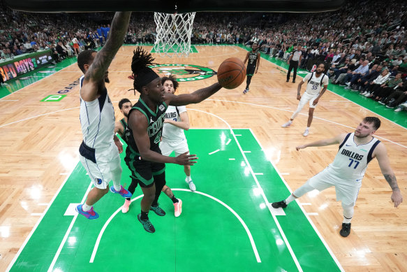 Jrue Holiday #4 of the Boston Celtics shoots the ball against P.J. Washington #25 of the Dallas Mavericks.