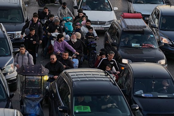People fleeing Israeli airstrikes in Dahiyeh on Thursday.