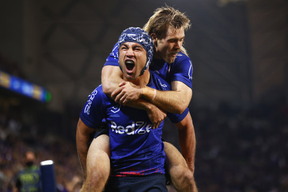 Storm halfback Jahrome Hughes and his former teammate Ryan Papenhuyzen.