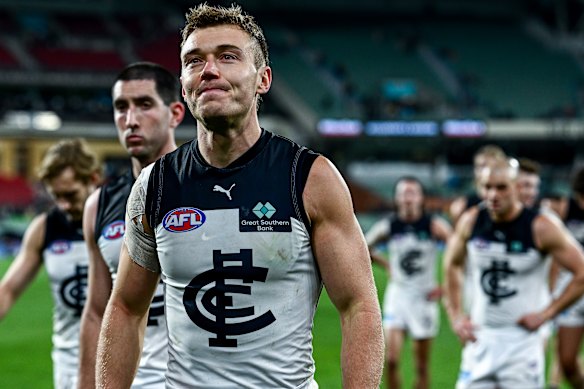 Patrick Cripps leads his teammates from the ground.