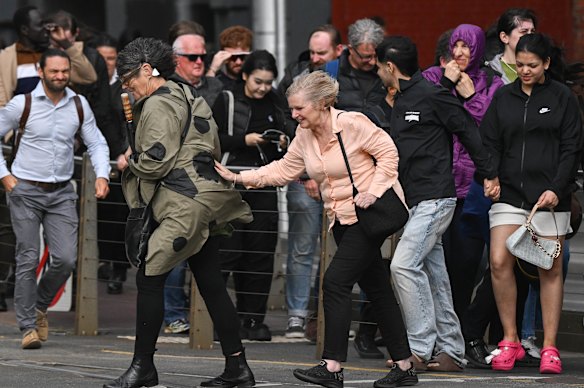 Melburnians battle strong winds in the CBD. 