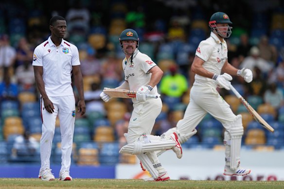 Australian batsmen Travis Head and Beau Webster bat on day three as West Indies fast bowler Shamar Joseph watches on. 