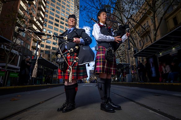 The Tartan Festival, celebrated 100 years since the world tour of the Australian Ladies Pipe Band, 100 female bagpipe players and drummers. At City Square after the annual Tartan Festival march are Helen Dilks, 75, with Scarlett Cai, 13.