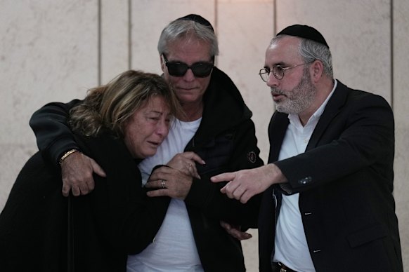 Annie, left, and Arieh, centre, mourn at the funeral of their son Dan Elkayam, a young French Jewish man who was killed in the mass shooting that targeted a Hanukkah celebration on Bondi Beach.