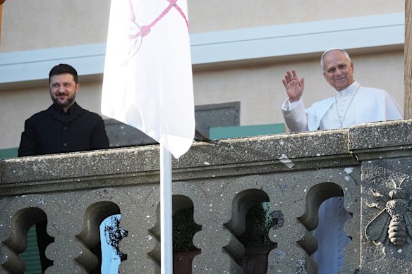 Ukraine President Volodymyr Zelensky and Pope Leo XIV wave to journalists during their meeting in Castel Gandolfo, Italy, on Tuesday.