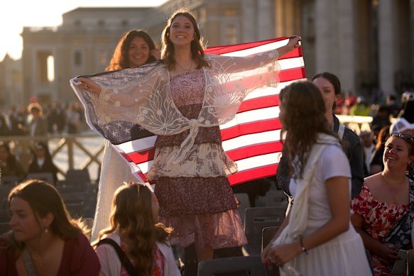 Well-wishers with an American flag ahead of the mass.