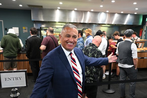 John Kanga with patrons spruiking the cheaper food options during a meeting at Sandown Racecourse in January.