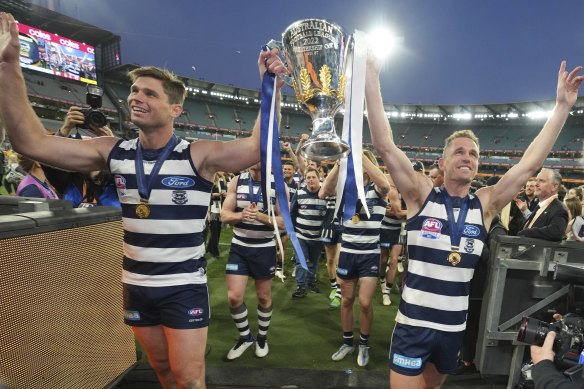 Tom Hawkins and large  mate Joel Selwood with the 2022 premiership cup.