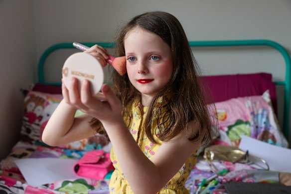 Billie Johnston, 8, applying makeup. The primary school student has told her mother she wants to work at Mecca when she grows up. 