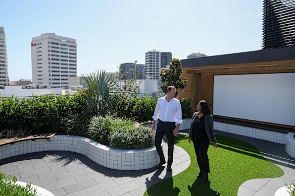 Capital Corporation director Jim Hunter  and GroupGSA associate director Noura Thaha in the rooftop garden that features a movie screen for residents’ use.