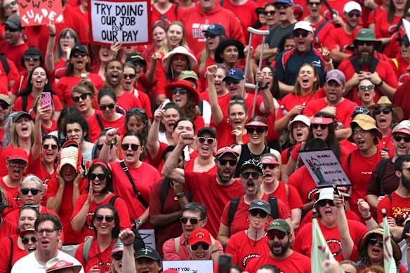 Teachers and staff rally at the steps of the Victorian parliament during a 24-hour strike over pay and conditions.