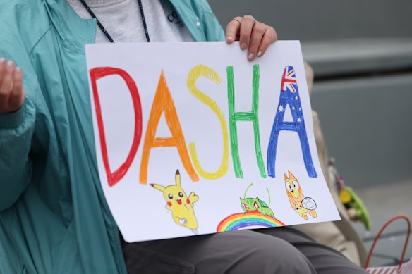 A fan holds a handmade sign for Daria Kasatkina at the 2025 French Open.