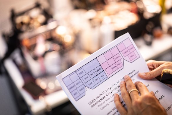 The presenter checks the script.