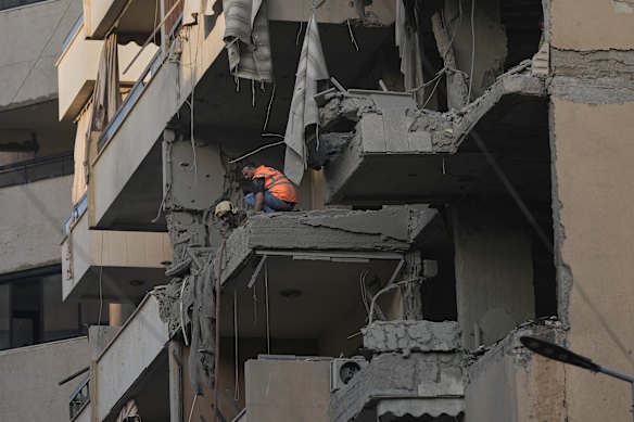 Civil Defence workers inspect site of the attack.