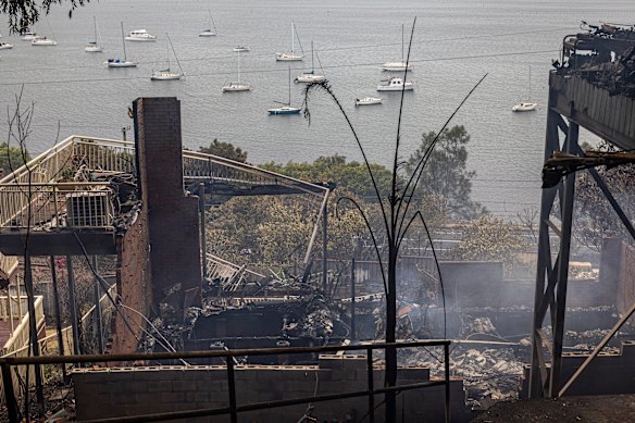 Homes and garages gutted by the Koolewong bushfire remain smouldering on Sunday.