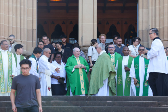 Priests and parishioners leave St Mary’s Cathedral in Sydney on Sunday morning.