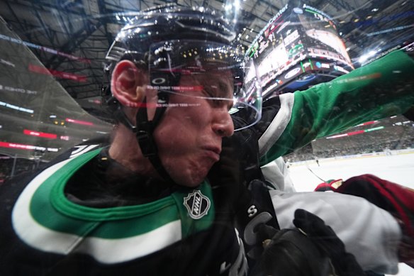 Dallas Stars defenseman Nils Lundkvist is checked by Minnesota Wild left wing Marcus Johansson in Game 1 of a first-round NHL Stanley Cup playoffs hockey series in Dallas.