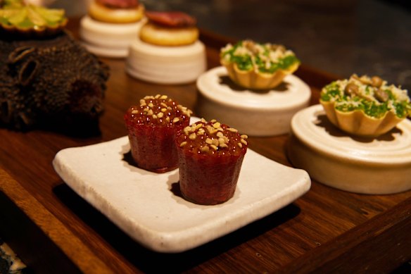 Pie-tee cases filled with beetroot, sour cream and smoked salmon roe.