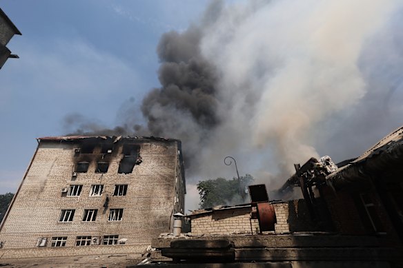 Ukrainian rescue workers put out a fire in a building hit by a Russian drone strike in Zaporizhzhia on Monday.