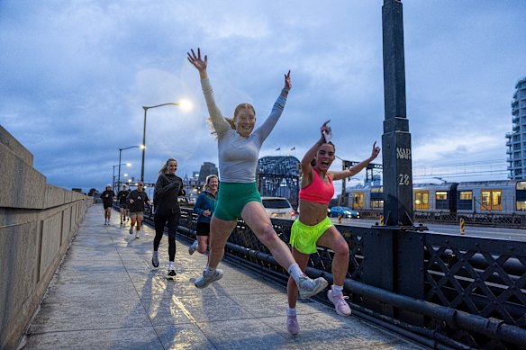 The Unofficial Run Club crosses Sydney Harbour as the sun rises on Friday morning. 