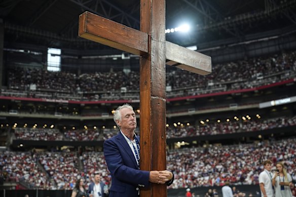 Dan Beazley stands with a cross inside State Farm Stadium.