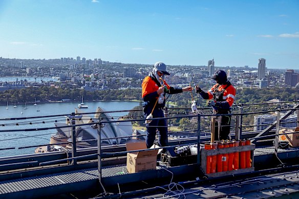 Some workers clock up 35,000 steps a day installing the fireworks on the bridge.