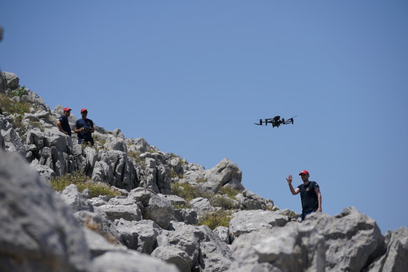 A member of the search team flying a drone on Symi as part of the search for Mosley.