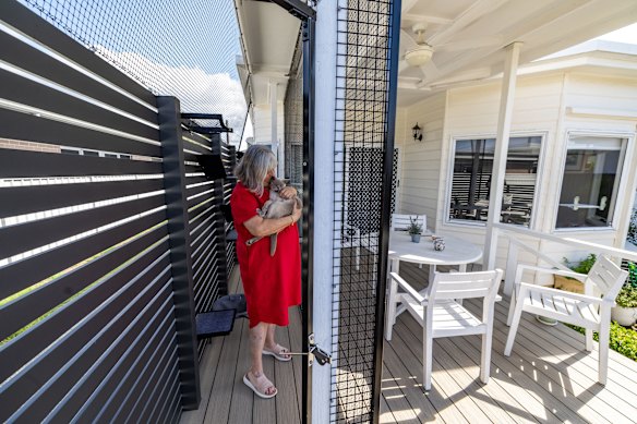 Lyndall Jones with her cat George on his catio.