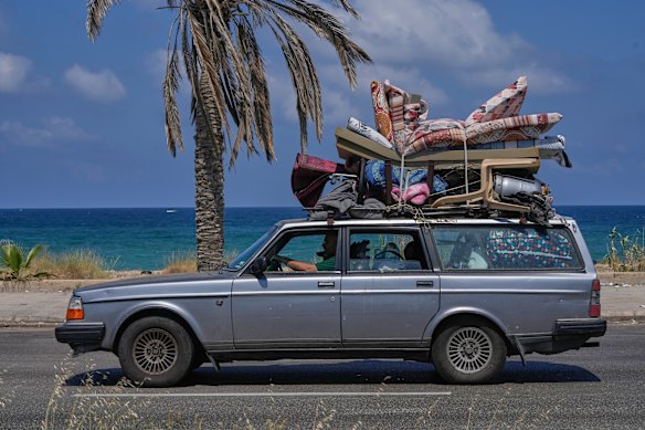A displaced family with their belongings, return to their village following a ceasefire between Israel and Hezbollah in the southern port city of Sidon, Lebanon.