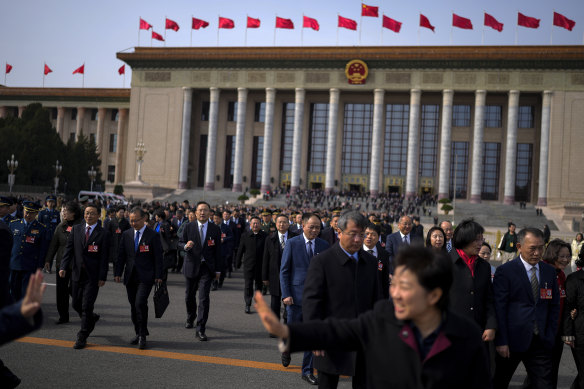 Delegates leave the Great Hall of the People after attending a preparatory session of the National People’s Congress in Beijing on Tuesday.