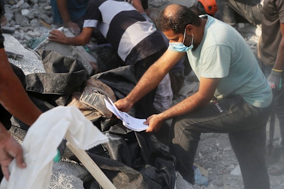 Rescue workers and residents search through the rubble in the aftermath of an Israeli-US strike on a girls’ elementary school in Minab, Iran.