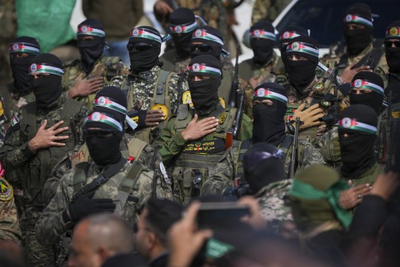 Hamas fighters prepare for the handover ceremony of Israeli hostages in Gaza on Saturday.