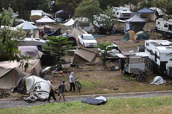 Locals in Wye River, help with the clean-up after a deluge of water swept through the campsites.
