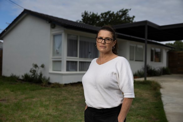 Lisa Woodall pictured in front of her late parents’ house.