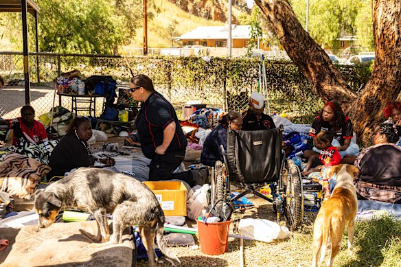 Grandmother Karen White waits at the Old Timers Camp as a detective of the Northern Territory Police speaks during the search for the five-year-old.