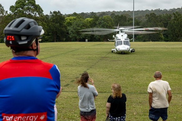 A helicopter lands at a nearby cricket oval to transport a crash victim to hospital. 