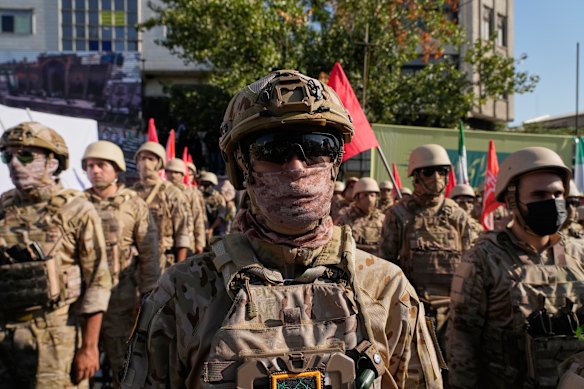Armed personnel take part in the parade.