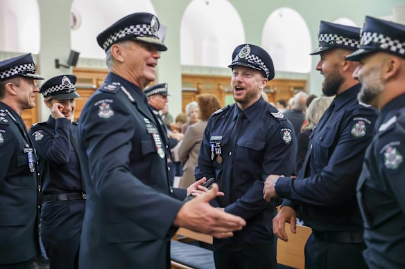 Chief Commissioner Mike Bush awarded Sergeant Brad Dettman (3rd from right) the Medal for Courage For his swift and courageous actions, under dangerous and volatile operational circumstances, in responding to an active shooter incident in Mordialloc, 2022 along with other award recipients at Victoria Police Academy.