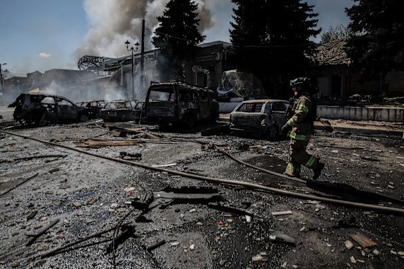Firefighters put out the blaze after a Russian drone hit the market in the Donetsk town of Druzhkivka on August 2.