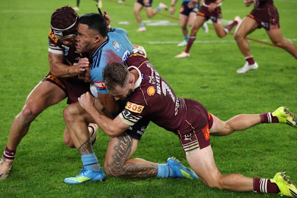 Kalyn Ponga connects with Tolu Koula.