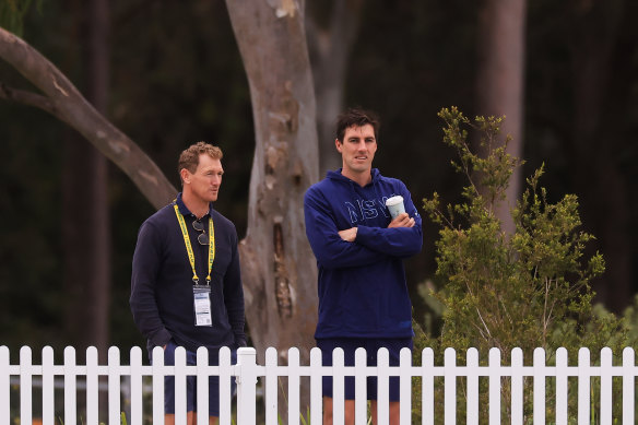 Chief selector George Bailey watches a Shield match alongside Pat Cummins.